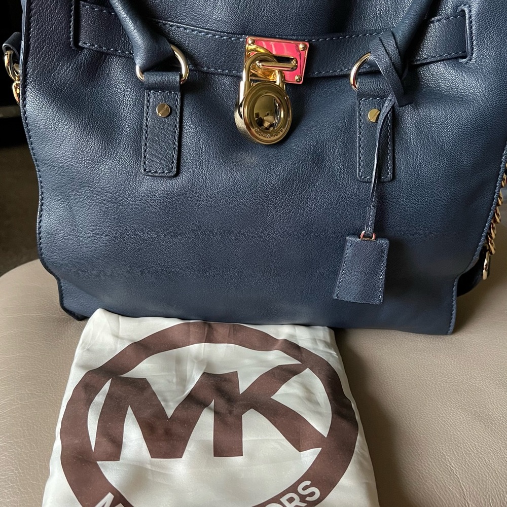 Blue leather Michael Kors pocketbook with strap barely used with protection bag.